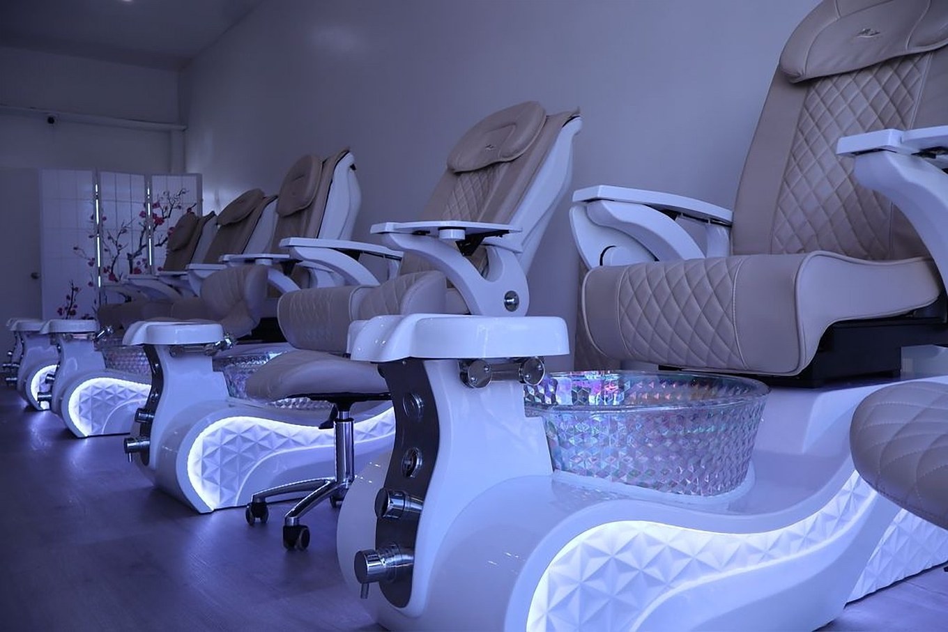 Row of premium pedicure spa chairs with LED-lit footbaths at Modern Nails LA