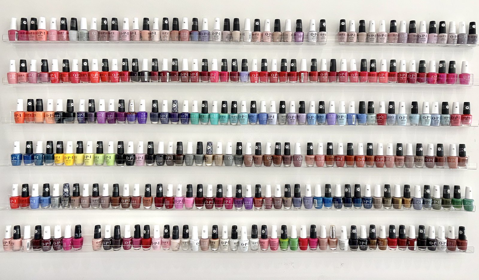 Wall of OPI and Dazzle Dry nail polish colors at Modern Nails LA